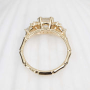 Gold ring with a bamboo design on a white background