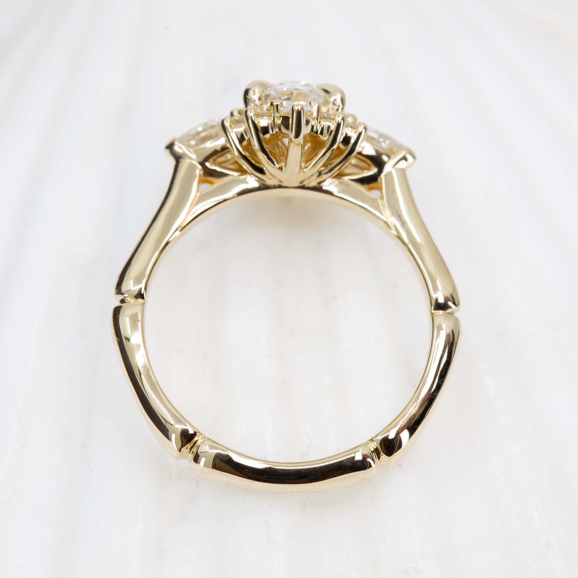 Gold ring with a diamond on a white background