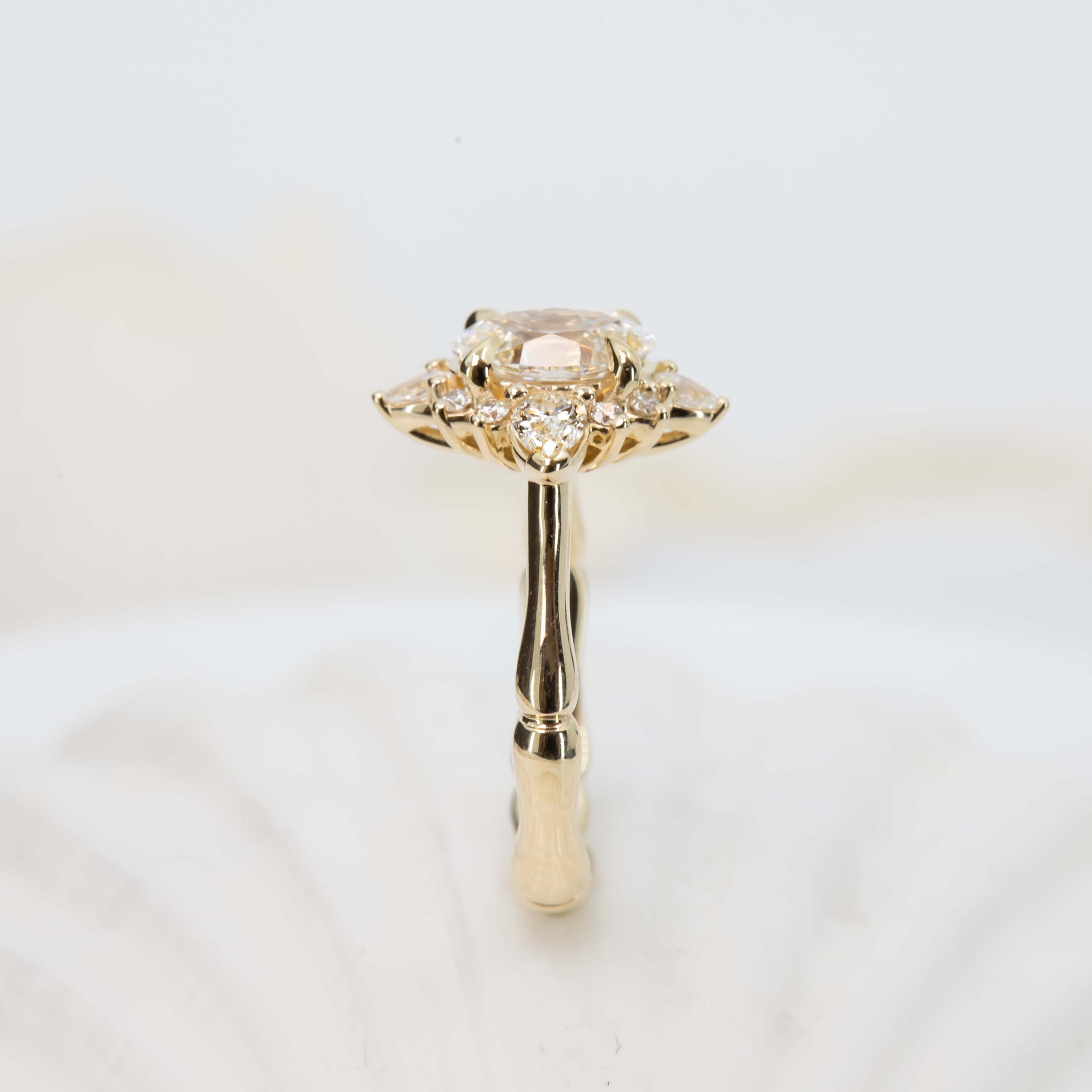 Gold ring with a diamond on a light background