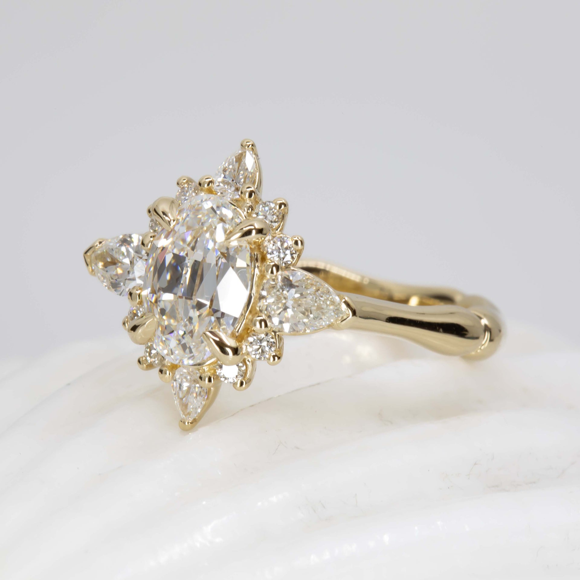 Gold ring with diamond stones on a light background