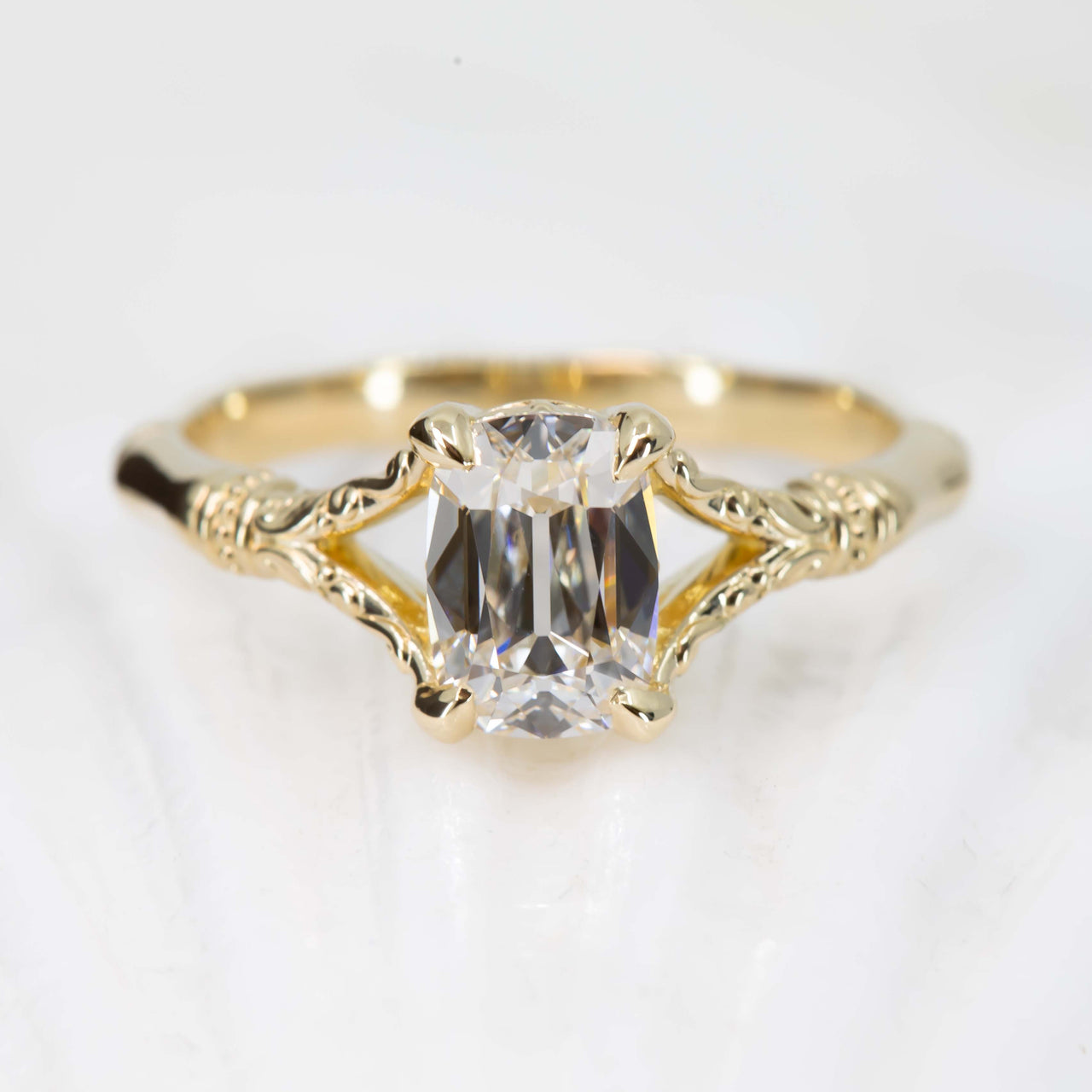 Gold ring with a diamond on a light gray background