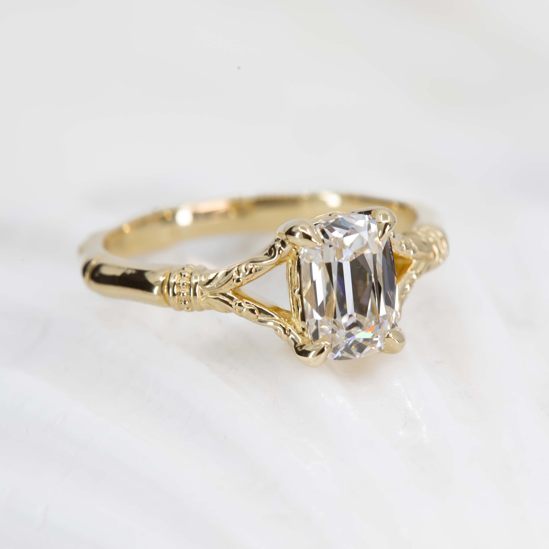 Gold ring with a clear gemstone on a white background