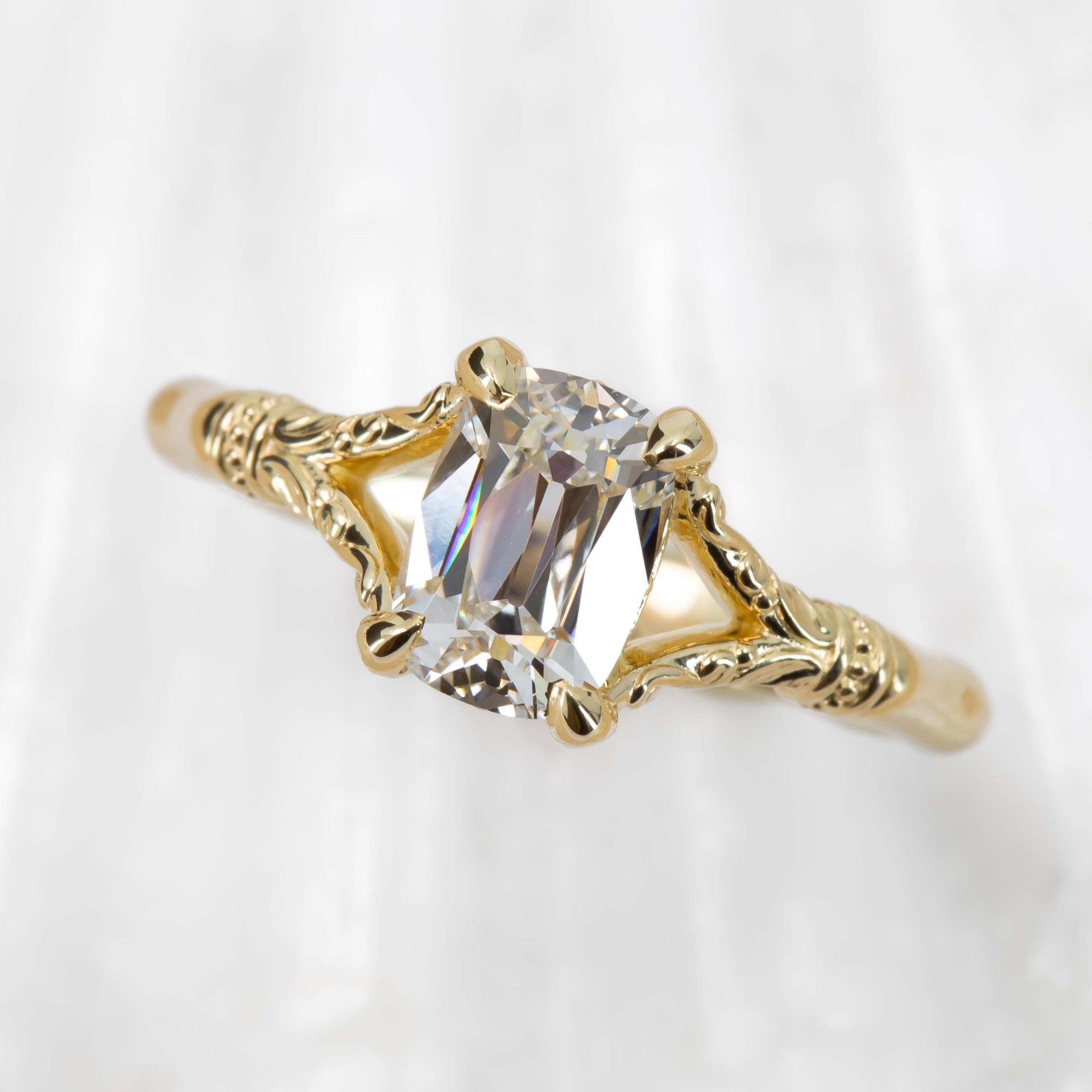 Gold ring with a diamond on a white background