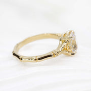 Gold ring with a diamond on a white background