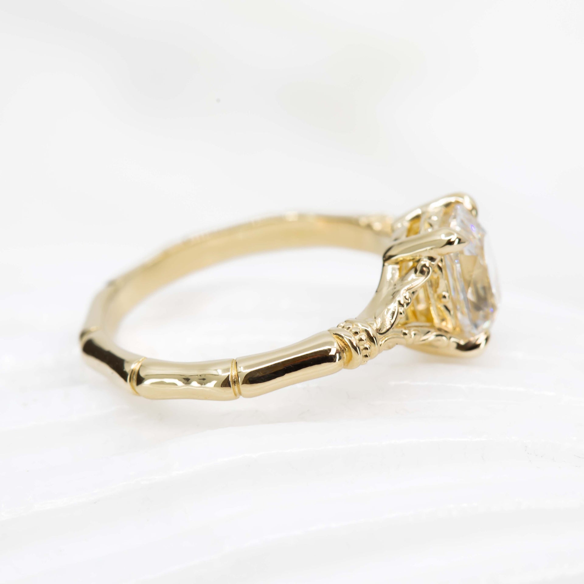 Gold ring with a diamond on a white background