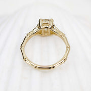 Gold ring with a diamond on a white background