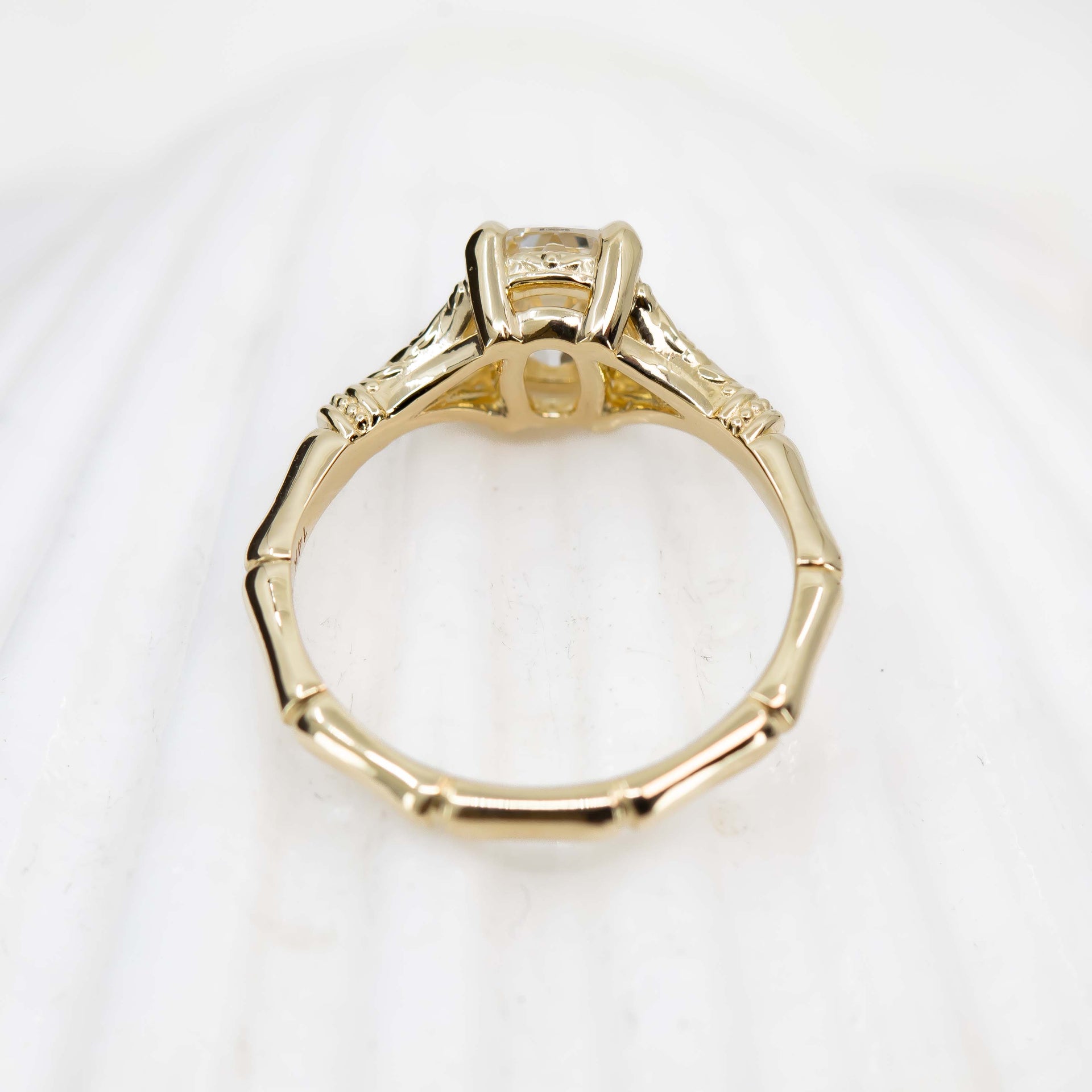Gold ring with a diamond on a white background