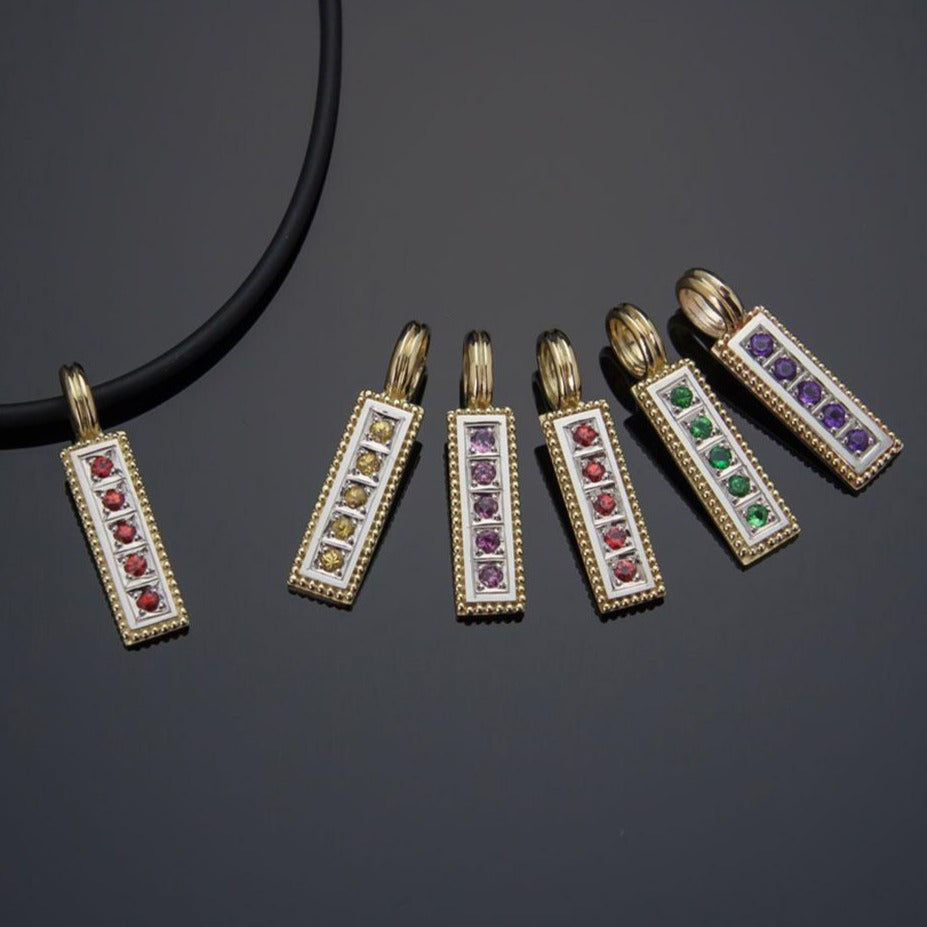 Collection of vertical 18K gold pendants with various gemstones