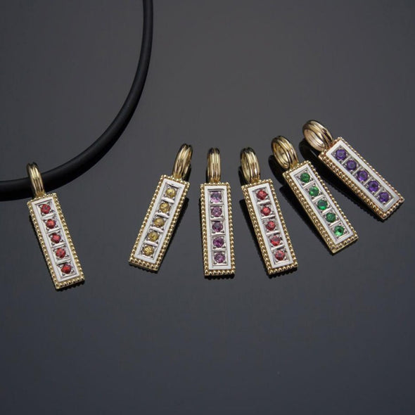 Collection of vertical 18K gold pendants with various gemstones